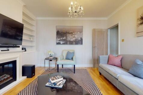 Bright, stylish living room with a wall-mounted...