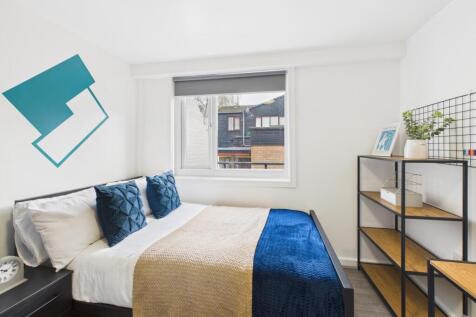 Bright, neatly presented bedroom with a comfort...