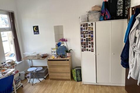 Bright bedroom with ample storage and desk spac...
