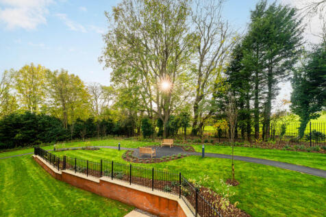 a park with a fence and trees