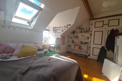 A bright and cozy master bedroom featuring a la...