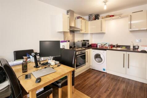 Bright open-plan kitchen with modern white unit...