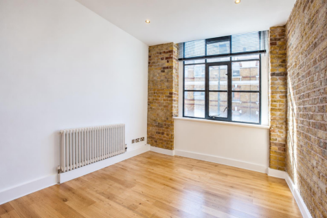 Empty Industrial Loft Room with Exposed Brick.png