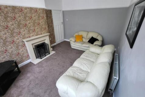 Bright, comfortable living room with light-colo...