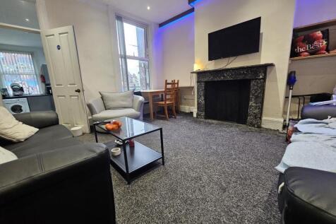 A spacious and modern living room featuring com...