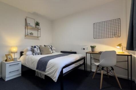 A bright and inviting double bedroom featuring ...