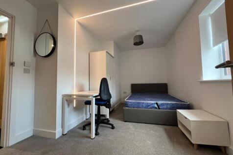 Bright, neatly presented bedroom with a comfort...