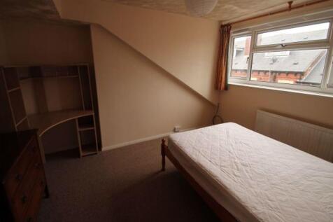 Cozy upstairs bedroom with a single bed, neutra...