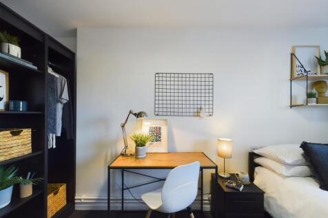 A stylish and well-organized double bedroom wit...