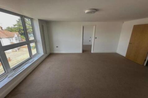 Bright, spacious living room with large windows...