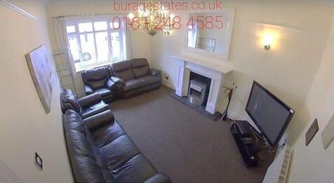 Spacious living room with leather sofas and TV...