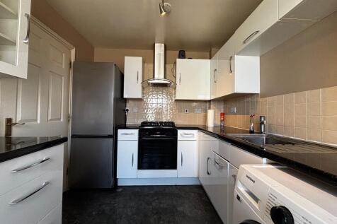 Modern kitchen with appliances and ample storag...