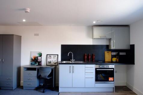 This modern kitchen features sleek cabinetry an...