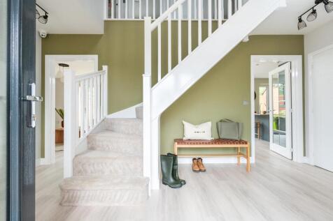 The large hallway is welcoming and provides plenty of space for storage