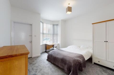 Bright, neutrally decorated double bedroom with...