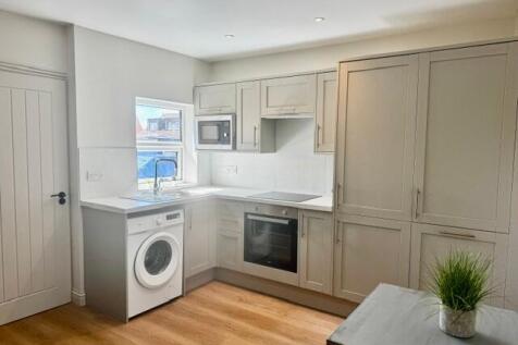 Modern fitted kitchen with sleek appliances...