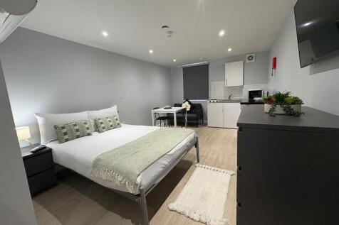 Bright, modern studio with a comfortable double...