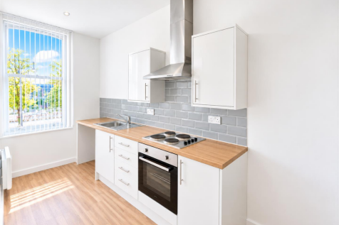 Bright Minimalist Kitchen with Empty Appliance Bay