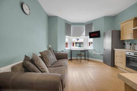 Bright open-plan lounge with cozy seating...