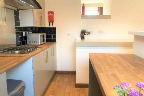 Bright and modern kitchen with wooden counterto...