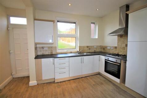 Bright modern kitchen with sleek white cabinets...