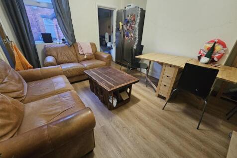 Bright, comfortable living room with leather so...