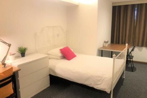 A bright and tidy single bedroom featuring a wh...