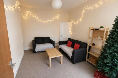 Cosy lounge with warm fairy lights and sofas...
