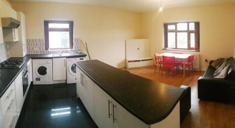 Bright open-plan kitchen and dining area with a...