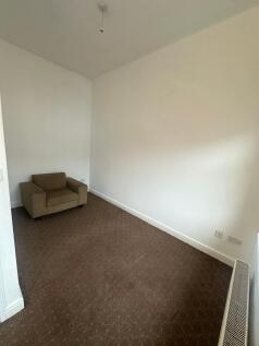 Simple living space with neutral painted walls,...