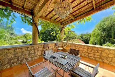 A charming outdoor patio features a rustic wooden 