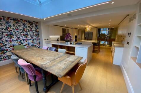 Bright open-plan kitchen and dining space with ...