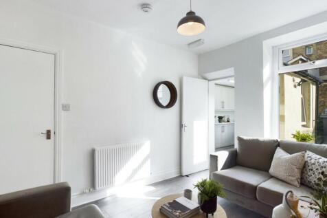 A bright and inviting large modern living room ...