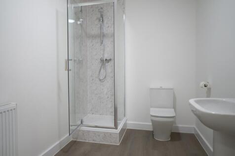 This modern bathroom features a sleek shower en...