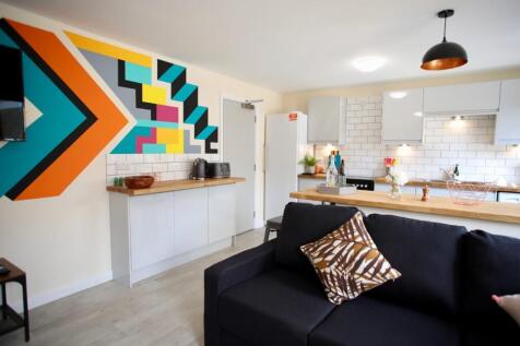 Bright, modern open-plan living area with a com...