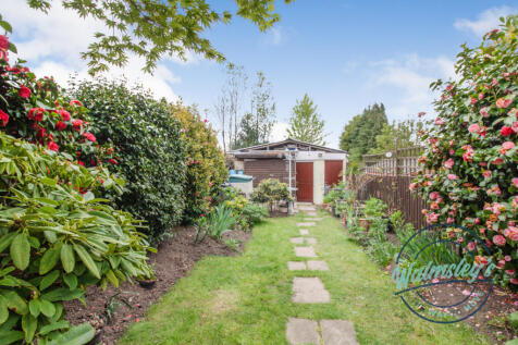 Private lawned garden with substantial rear garage