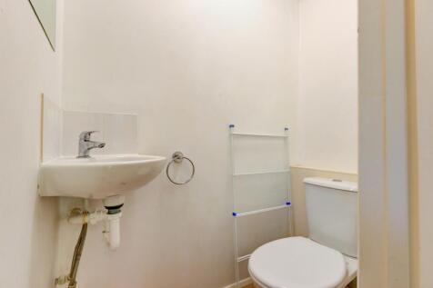 Compact, well-maintained WC with a wall-mounted...