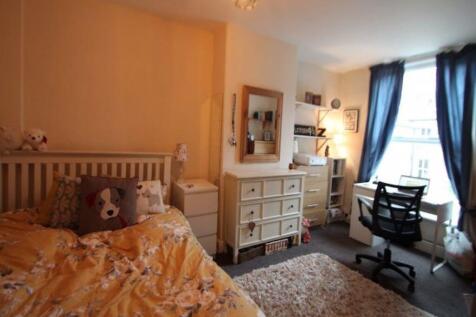 A cozy and well-maintained bedroom featuring a ...