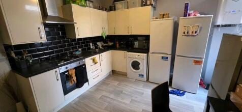 Modern kitchen with appliances and ample storag...
