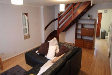 A well-lit, cozy living room featuring comforta...