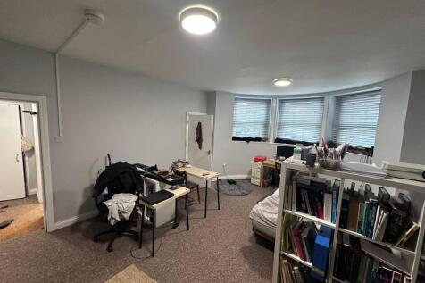Spacious double bedroom with a curved bay windo...