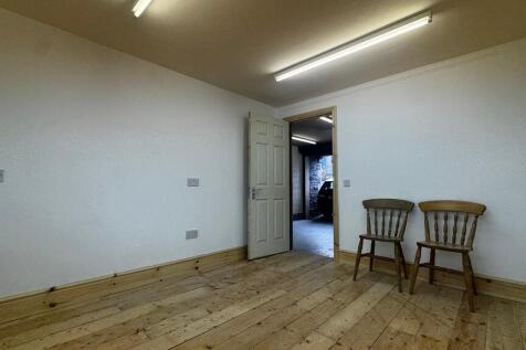 Versatile workspace with charming wood flooring...