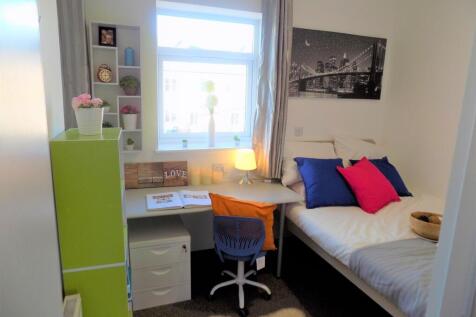 Bright, neatly furnished single bedroom with a ...