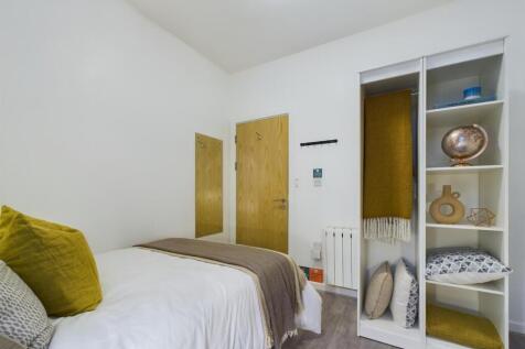 A bright and inviting double bedroom featuring ...