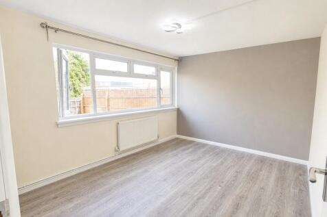 Bright double bedroom with modern grey flooring...