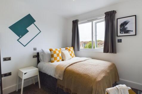 A bright and inviting double bedroom featuring ...