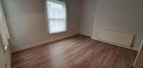 Modern room with bright window and wood floorin...