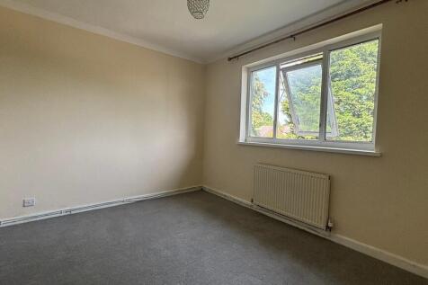 Bright and airy bedroom with large window view...