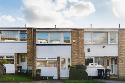 A well-maintained terraced house featuring whit...