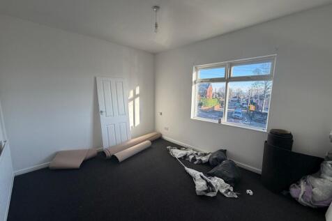 Bright, freshly painted bedroom with a large fr...